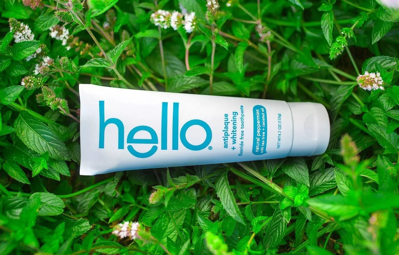 A bottle of Hello antiplaque + whitening fluoride toothpaste with a natural peppermint flavor