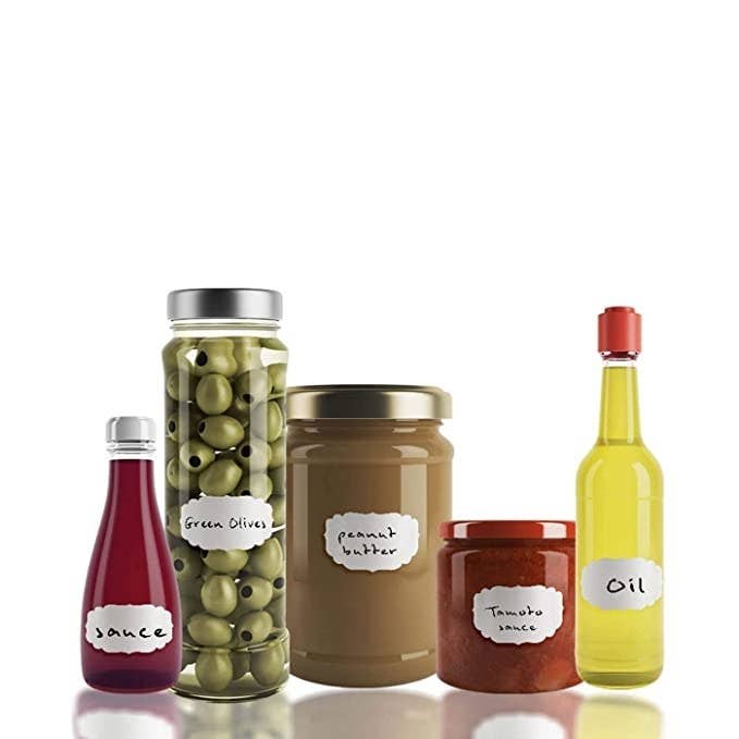 Bottles and jars of olives, oil, peanut butter and sauce labelled with the stickers.