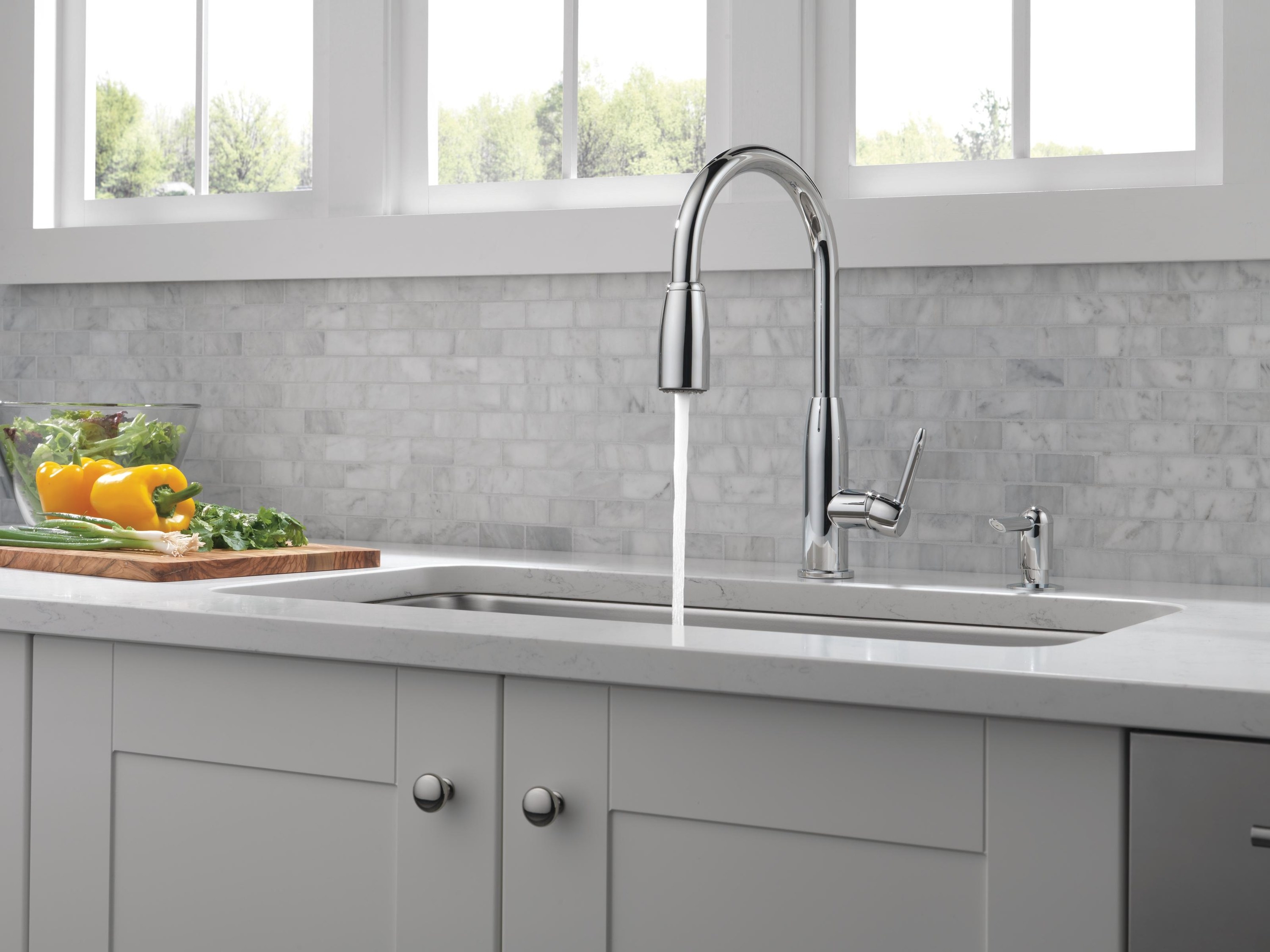 The faucet, running a single stream of water