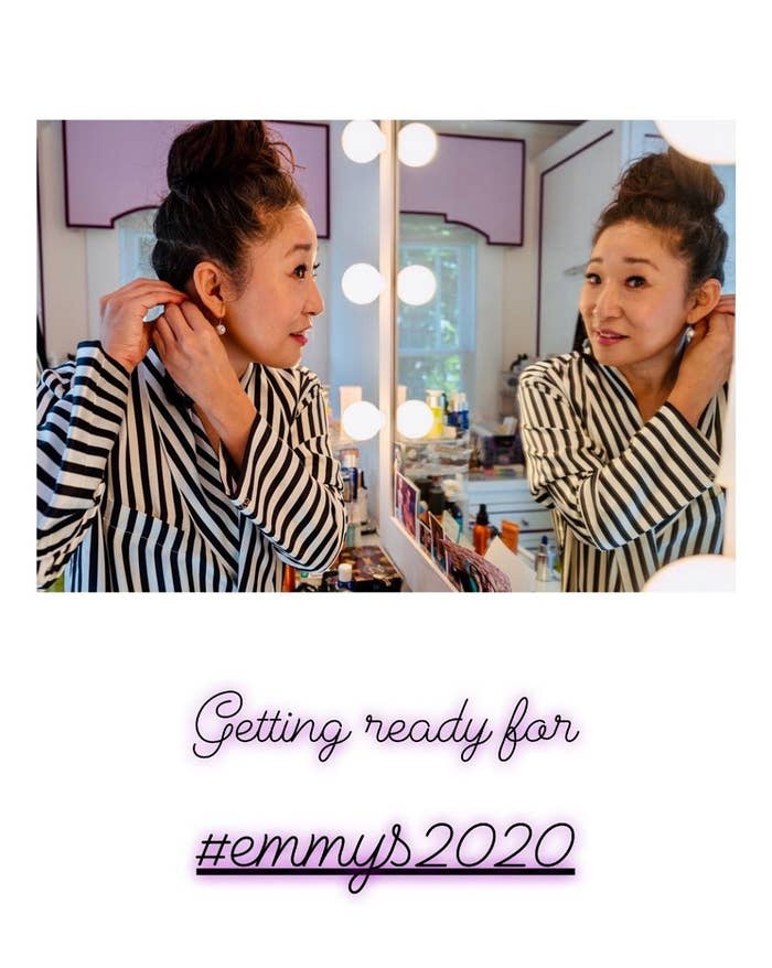 Sandra Oh putting on earrings and getting ready for the Emmys 