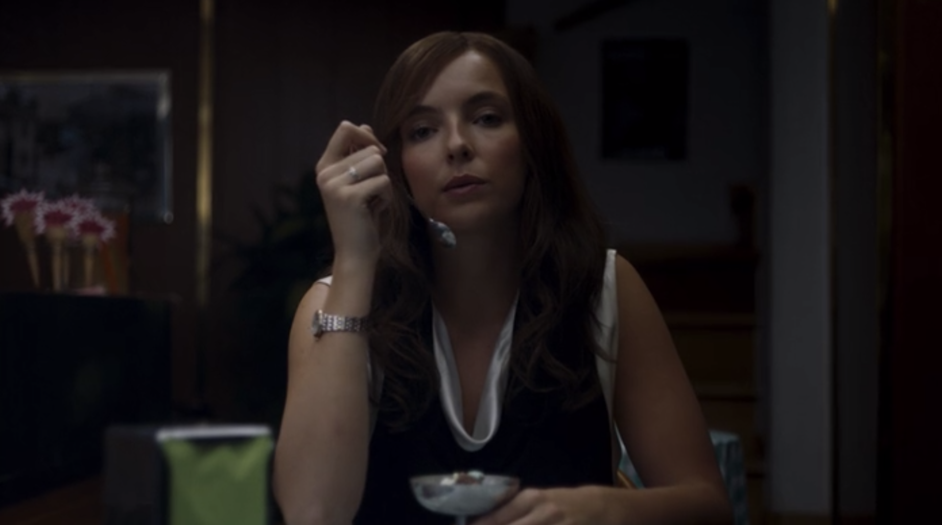 Villanelle staring at a little girl while eating ice cream. 