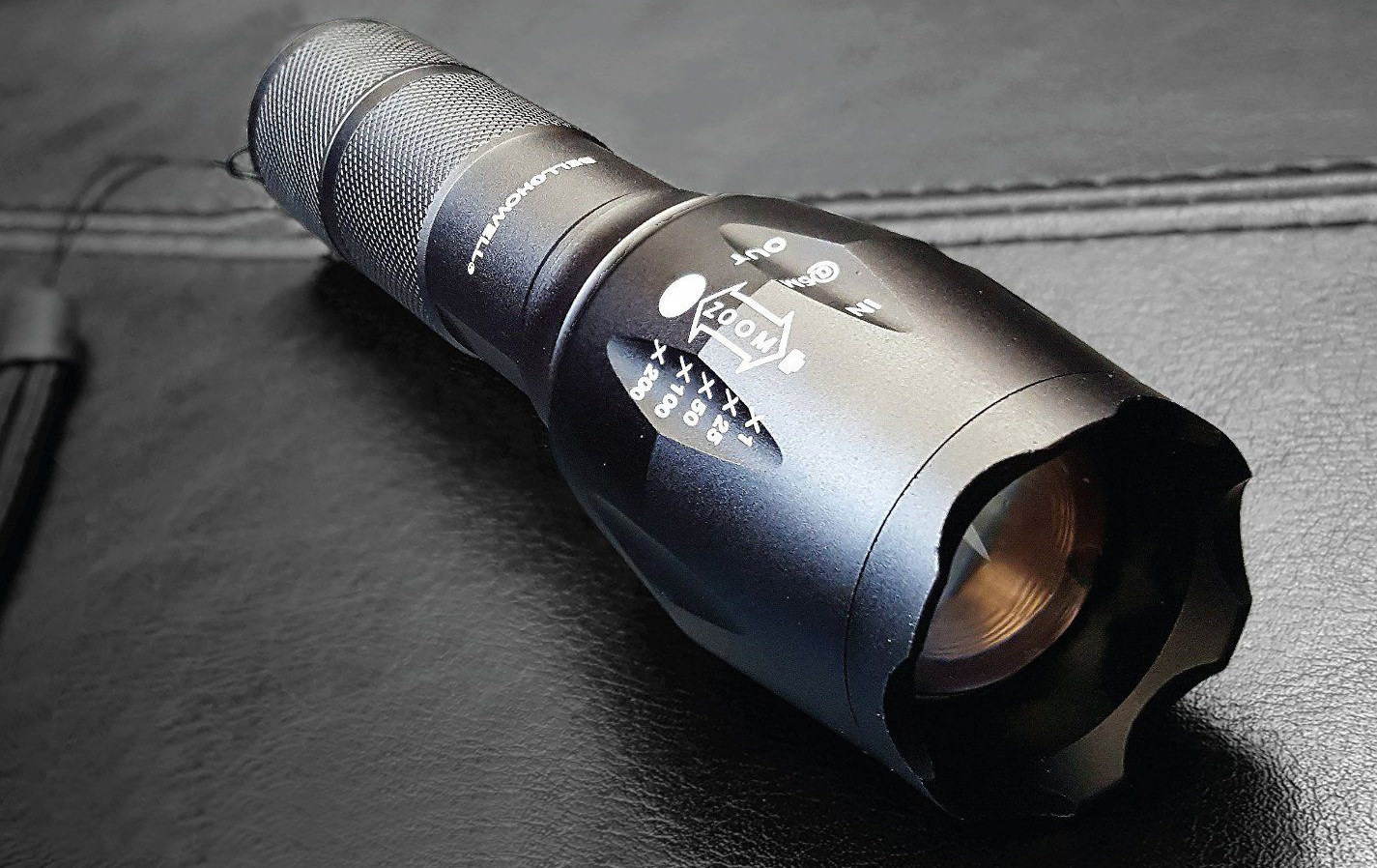 taclight LED flashlight on a leather seat