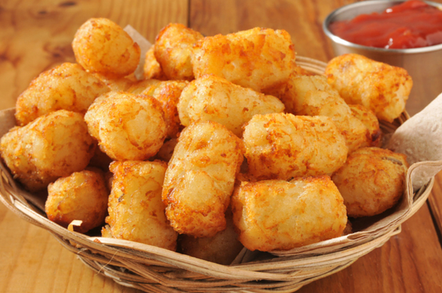 A basket of golden tater tots with a side of ketchup
