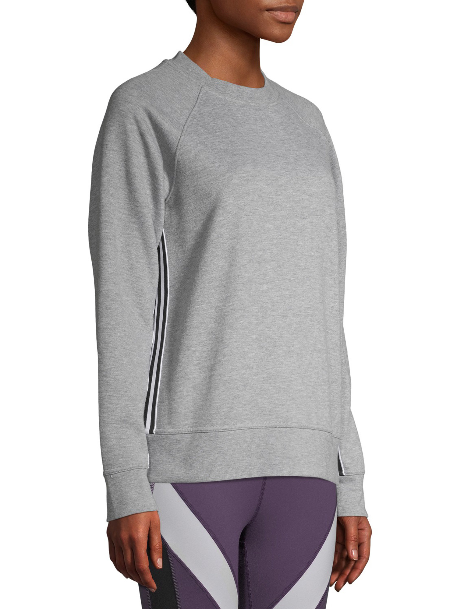 A model wearing the grey sweatshirt with a side stripe