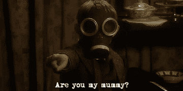 a little boy in a gas mask pointing and asking &quot;Are you my mummy?&quot;