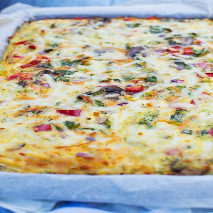 A sheet pan frittata with lots of vegetables and cheese.