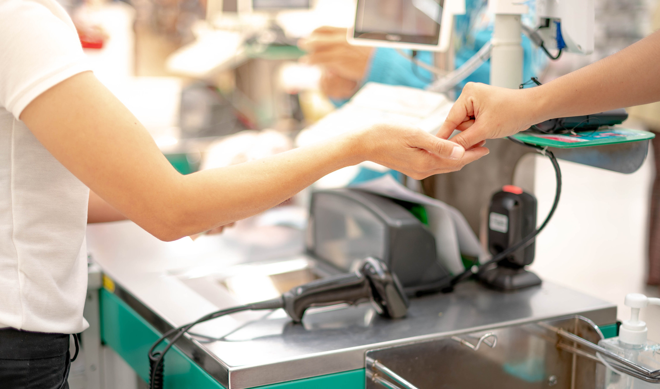 A person paying for their groceries in cash.