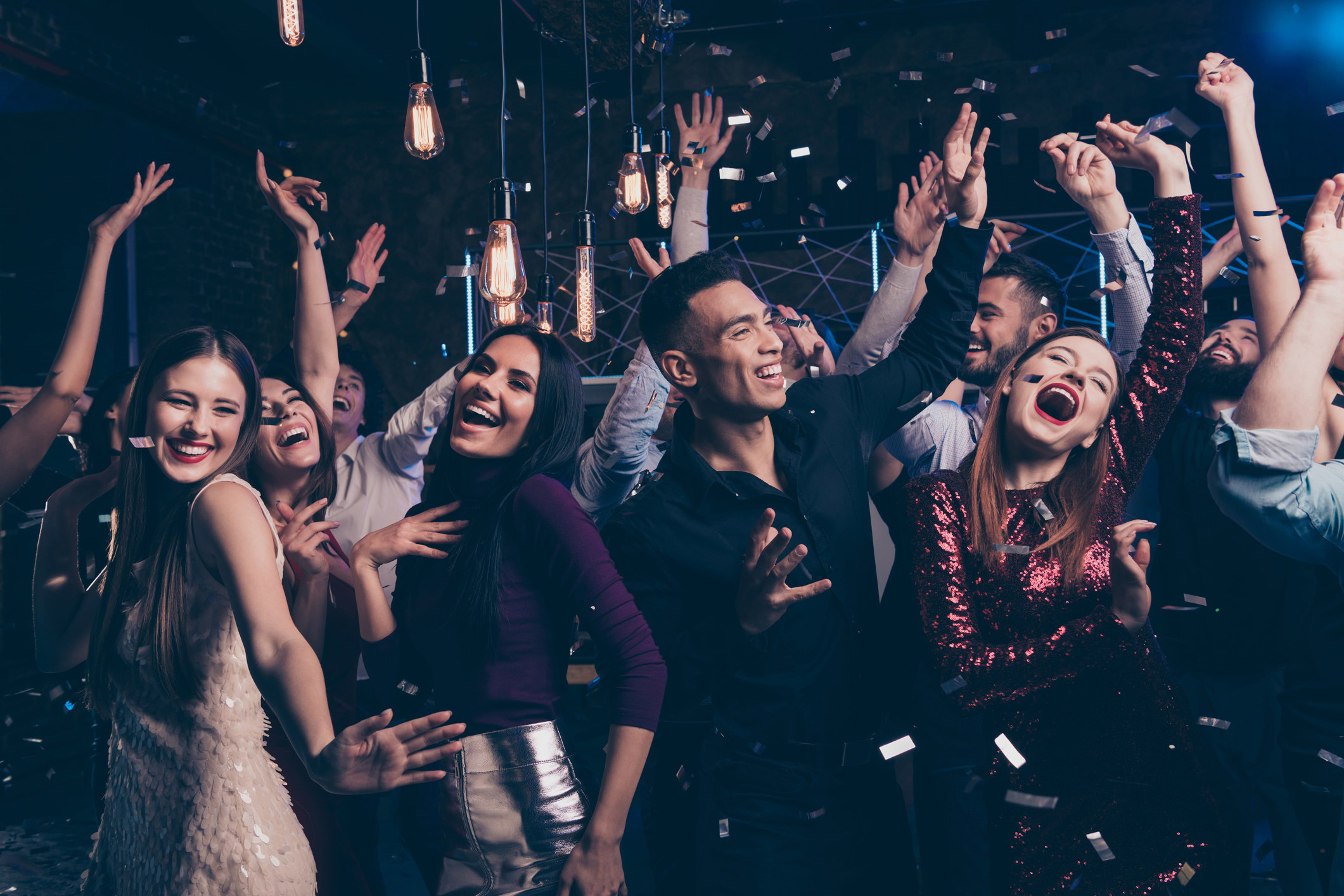 A group of people dancing at a club.