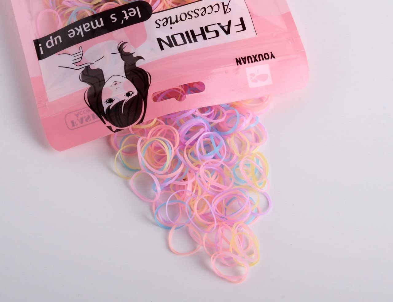 An open package of elastics with many spilling out the top
