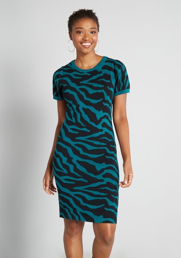 A model wearing the teal and black short-sleeve dress that hits above the knee