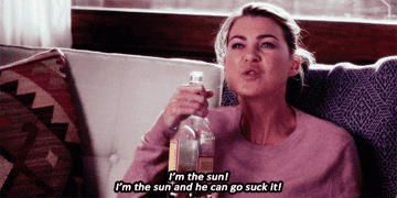 Meredith angry on the couch and drinking liquor straight from the bottle