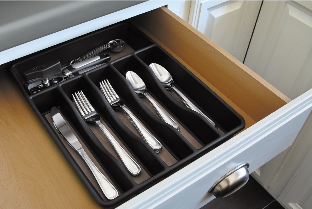 The cutlery organizer in a white wood drawer