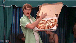 Kendall presents a heart-shaped pizza.