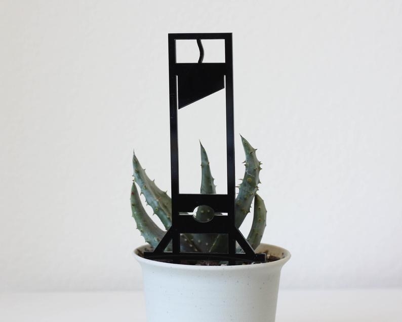 Solid black guillotine decor in pot with succulent 