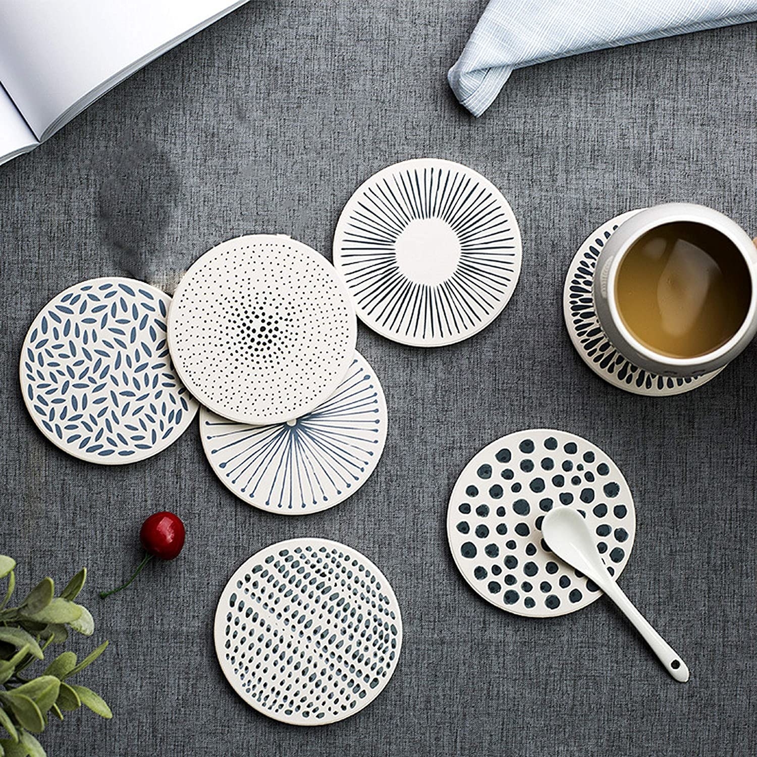 Five coasters with varying patterns in white and black or gray 