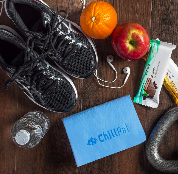 A blue cooling towel that says &quot;ChillPal&quot; next to protein bars, a water bottle, and black running sneakers