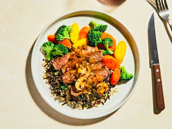 plate of Truffled Mushroom Steak with Spinach & Wild Grain Sauté