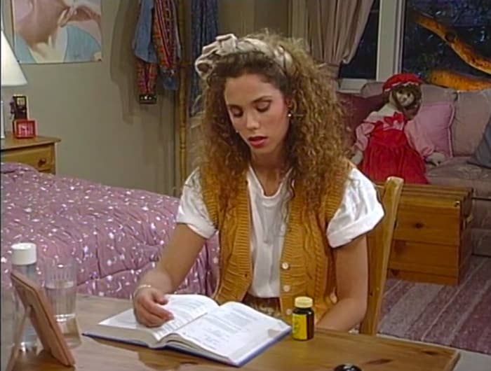 Jessie on the verge of falling asleep, trying to study at her desk