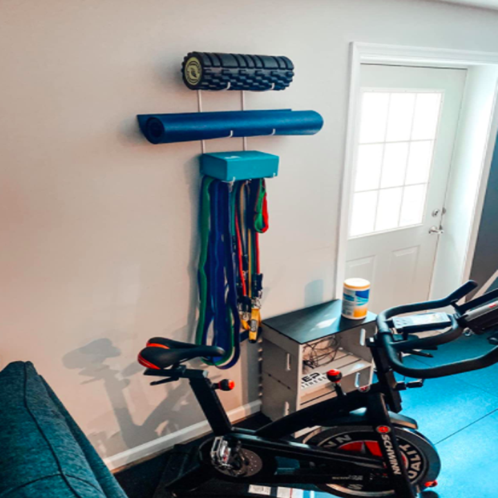 Reviewer uses same wall mount for yoga mats and a foam roller in their home gym