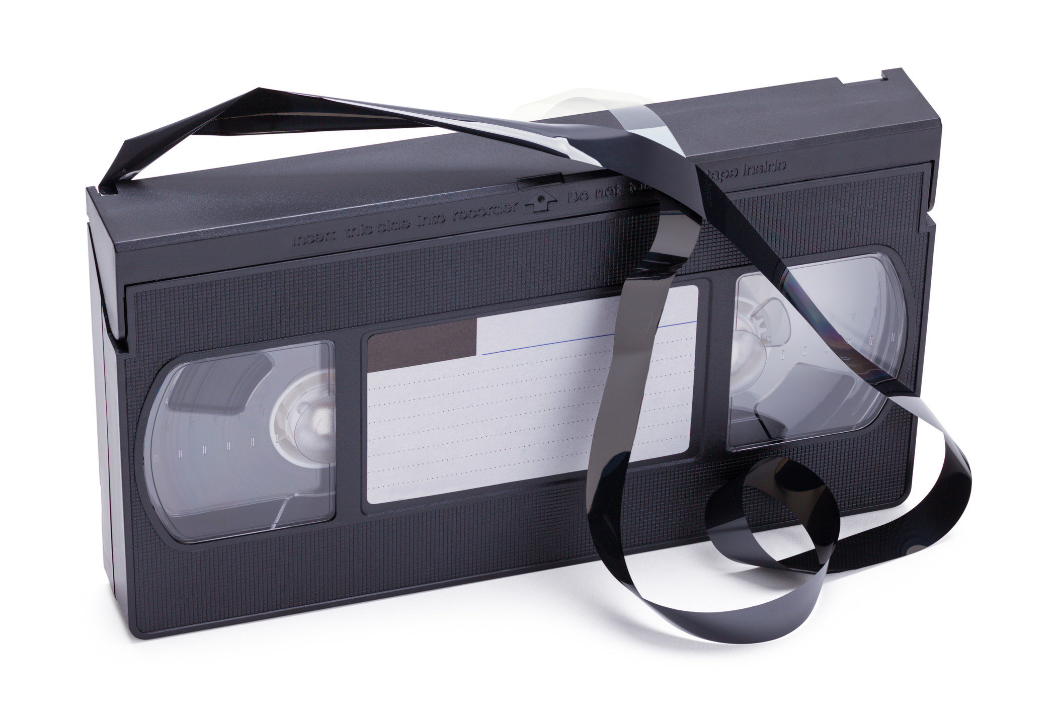A photo of a VHS with the tape yanked out of it