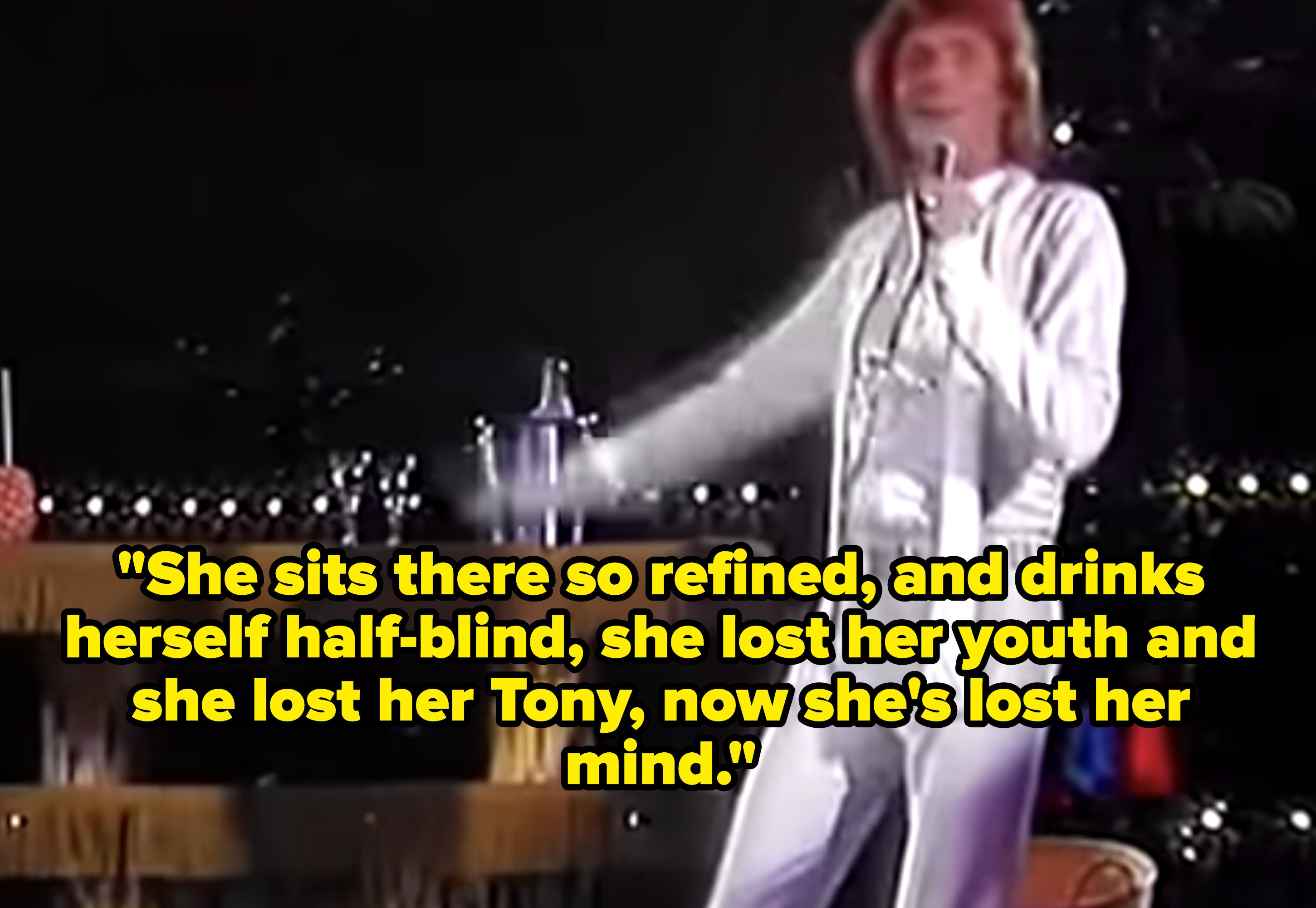 Barry Manilow singing in a bright, white suit.