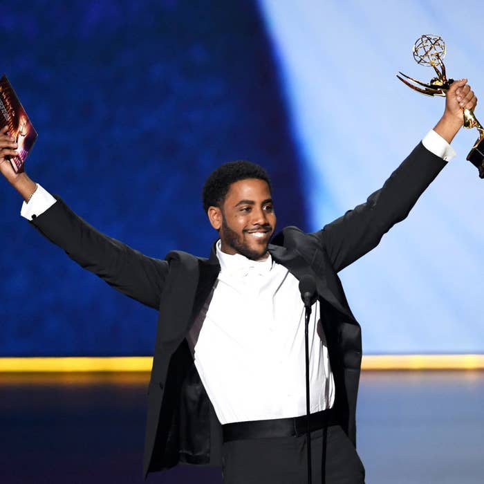 Jharrel holding his Emmy on stage