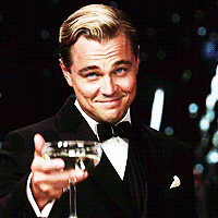 Gatsby from The Great Gatsby lifts his glass to cheers 