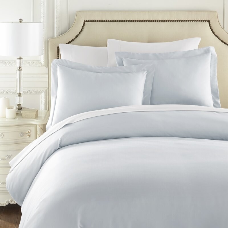 A pale blue duvet cover set on a bed 