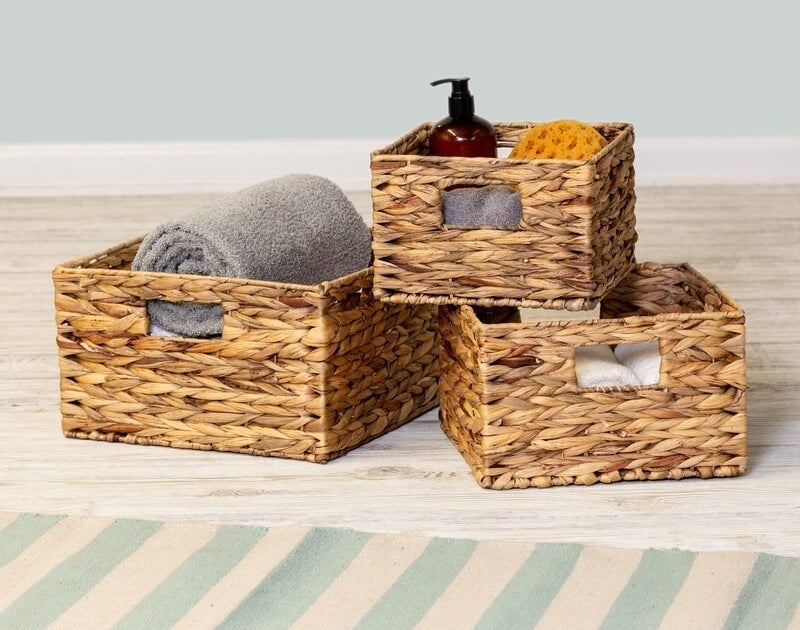 Three rattan baskets with holes for handles