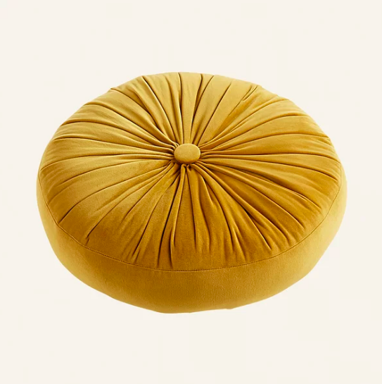 Round yellow pillow with button in center 