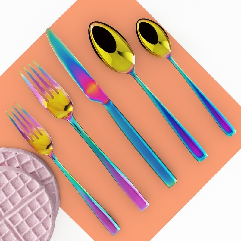 Set of rainbow reflective cutlery — two forks, a knife, two spoons 