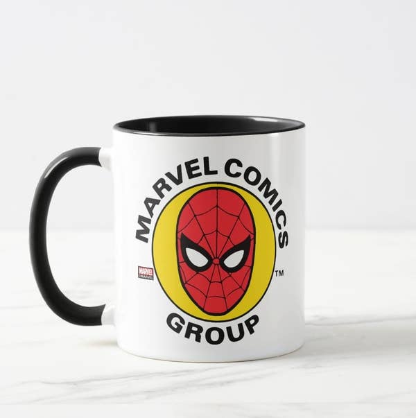 White mug with black handle and interior with Spider-Man face logo