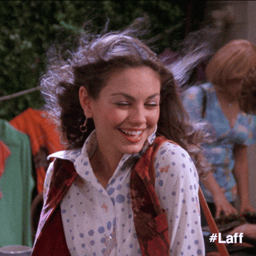 A gif of Jackie from That 70&#x27;s Show flipping her hair