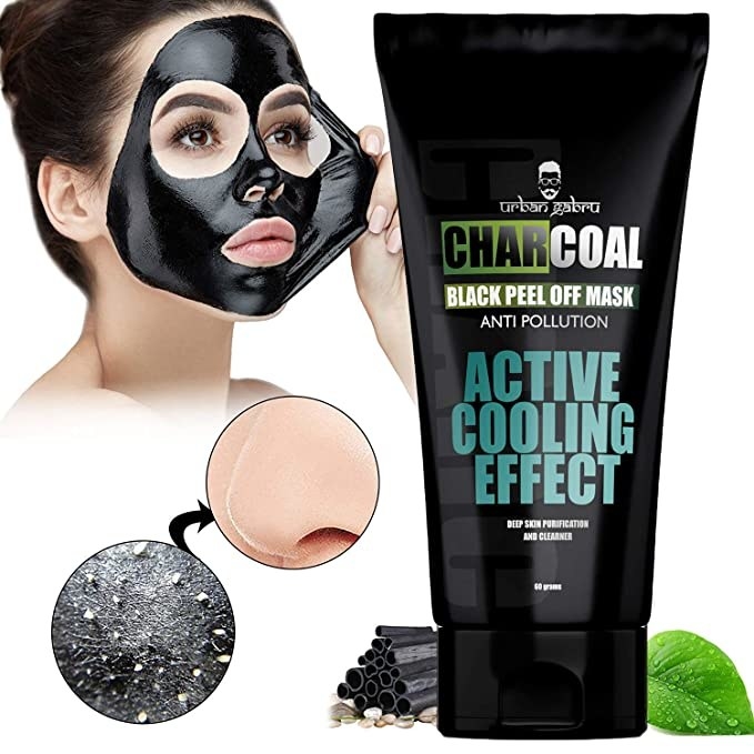 Woman peeling the charcoal mask from her face.