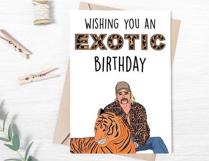 The white card featuring an illustration of Joe Exotic and a tiger with the words &quot;Wishing you an exotic birthday&quot; written on it