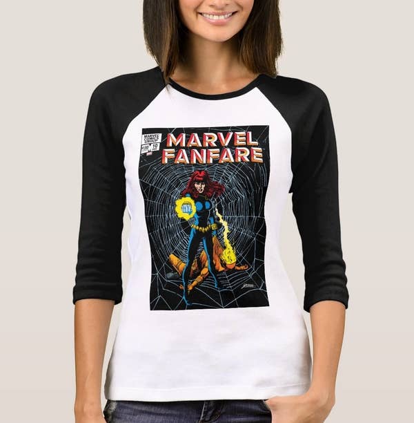 Model wearing a white raglan T-shirt with black sleeves and a Black Widow cover to Marvel Fanfare