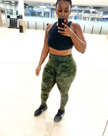 A reviewer wearing the leggings in green camo. 