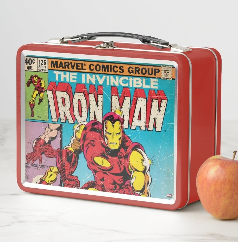 A metal lunchbox with a black plastic handle featuring a classic Iron Man comic cover