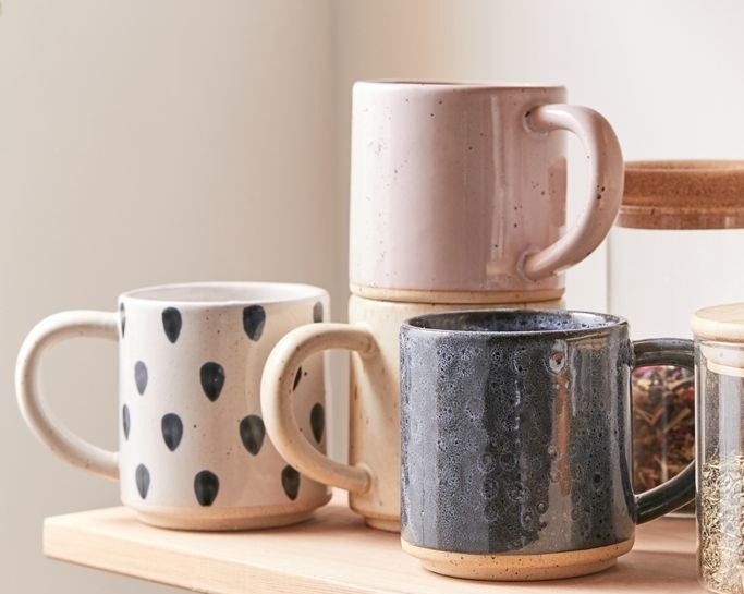 Ceramic mugs with natural boho designs, featuring one perfectly stacked on another