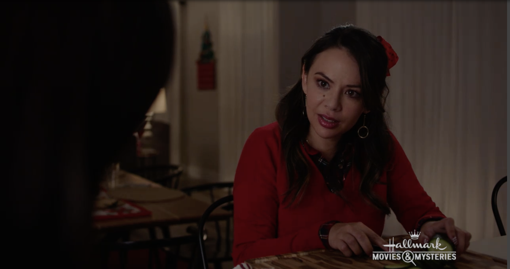 Janel Parrish wearing a holiday sweater