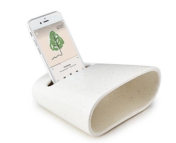 A ceramic phone amplifier with a minimalist speckled white design