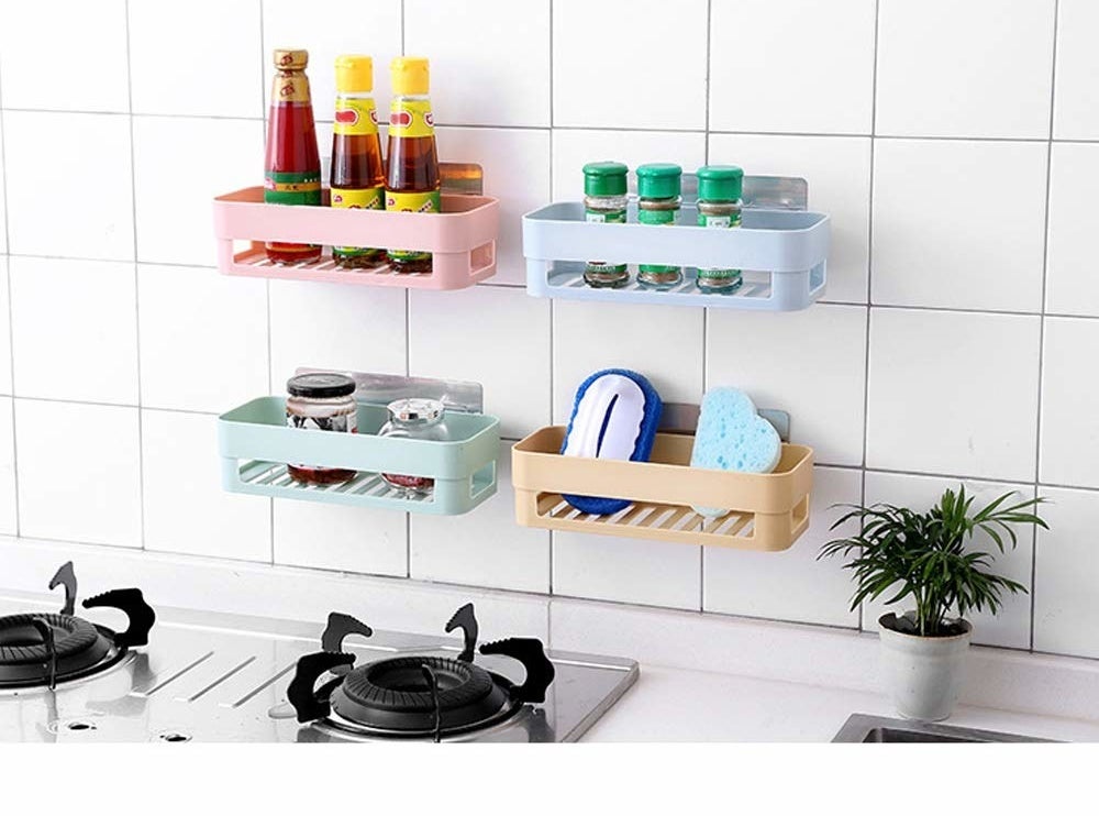 Four pastel coloured shelves on a tiled kitchen wall with pantry products on them