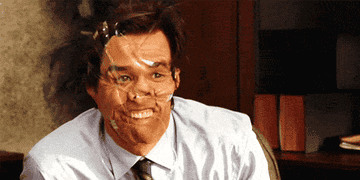 Jim Carrey waves like a weirdo with a tape all over his face