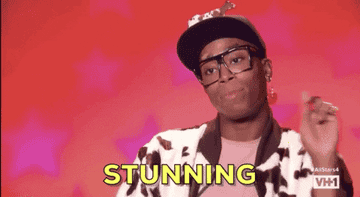 Monique Heart in the TV show &quot;Ru Paul&#x27;s Drag Race&quot; holding up their finger and saying &quot;Stunning&quot;. 