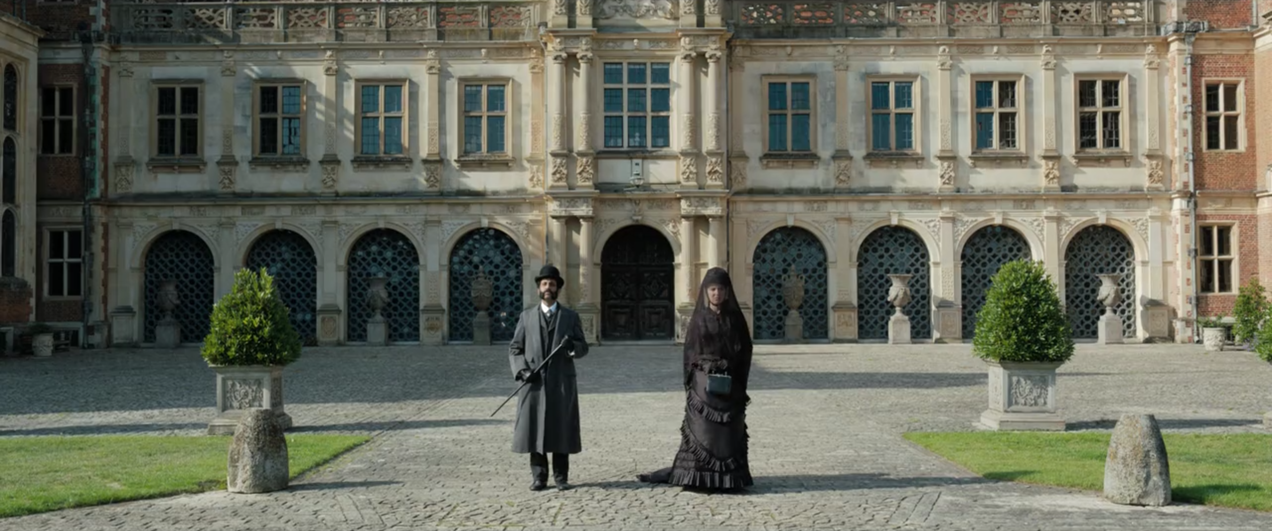 The Scottish Yard officer and Enola stand apart outside Basilwether mansion.