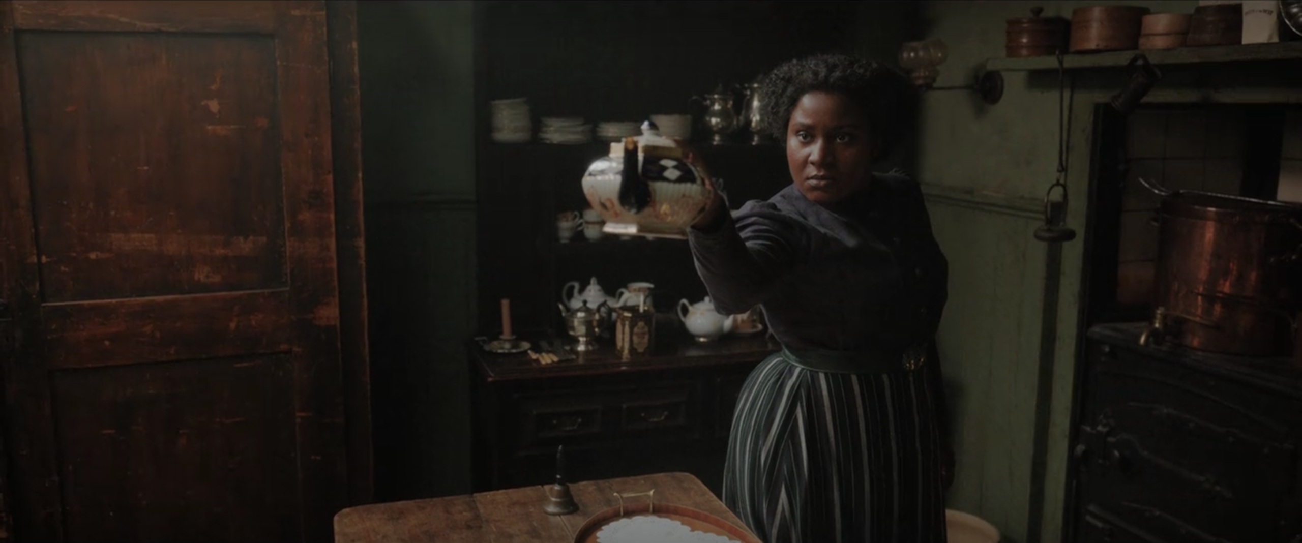 Edith pointing a teapot menacingly at an off-screen Sherlock.