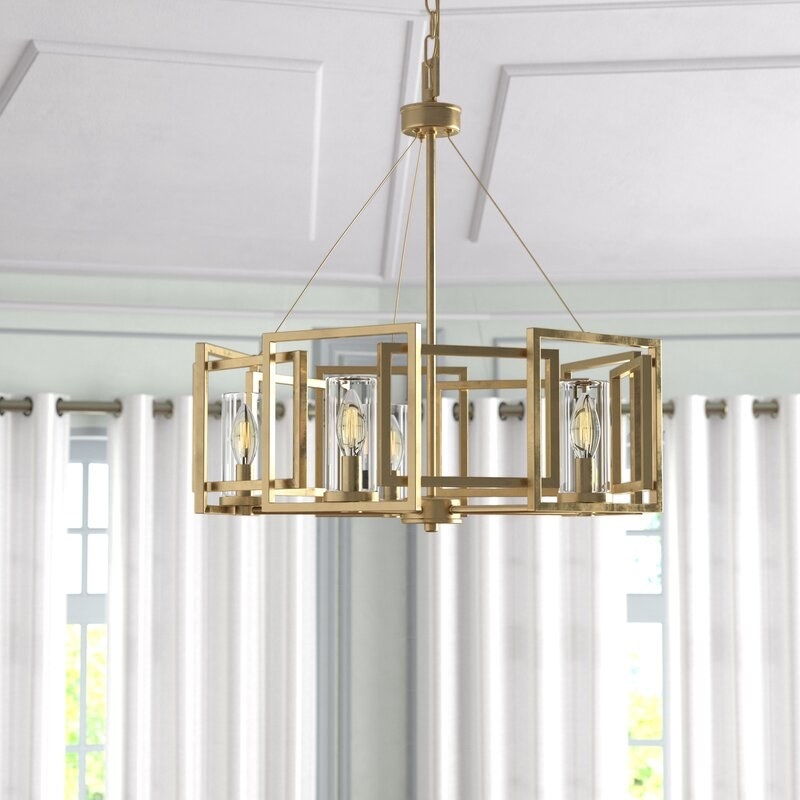 The round chandelier with square brass decorations around the outside