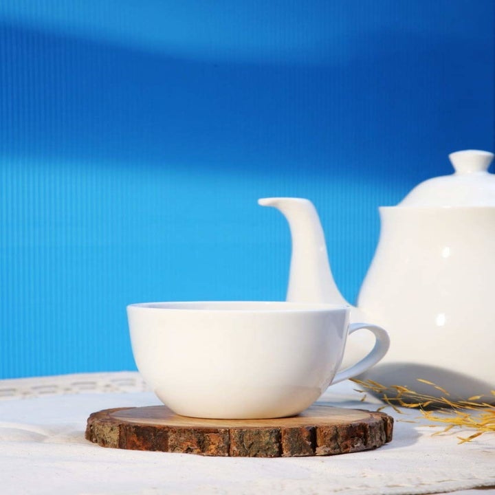 The wooden coaster pictured with a tea cup on top.