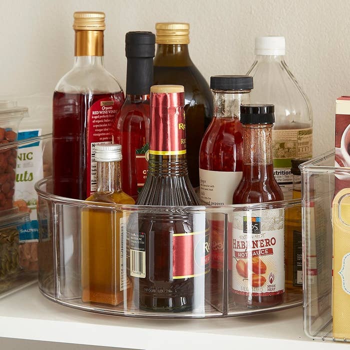 clear lazy suzan with compartments and high sides full of condiments