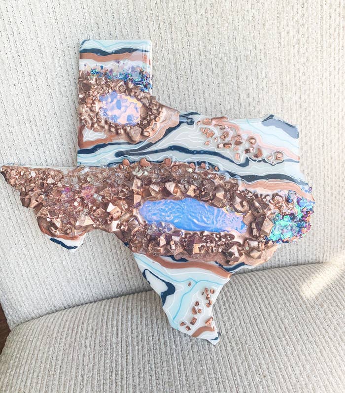 The shape of Texas with a marbled pink and blue design along with a rose gold geode design